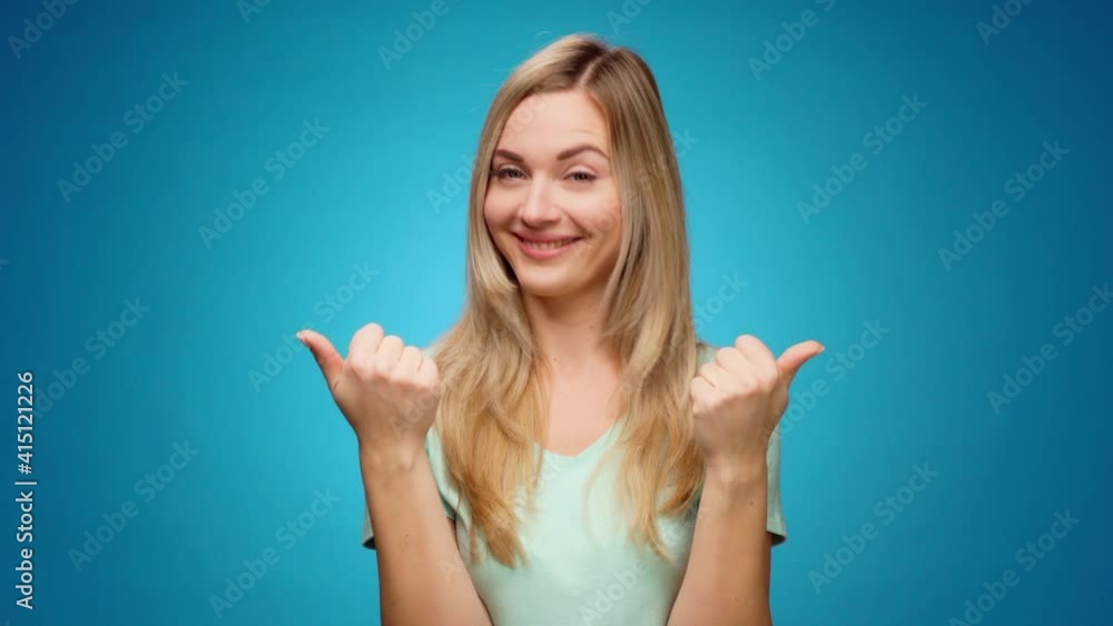 Young woman showing gesture of wasting money against blue background, materialist, shopping concept Young woman showing gesture of wasting money against blue background, materialist, shopping concept