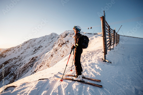 Mountaineer backcountry ski walking in the mountains. Ski touring in high alpine landscape. Adventure winter extreme sport. Sunny day