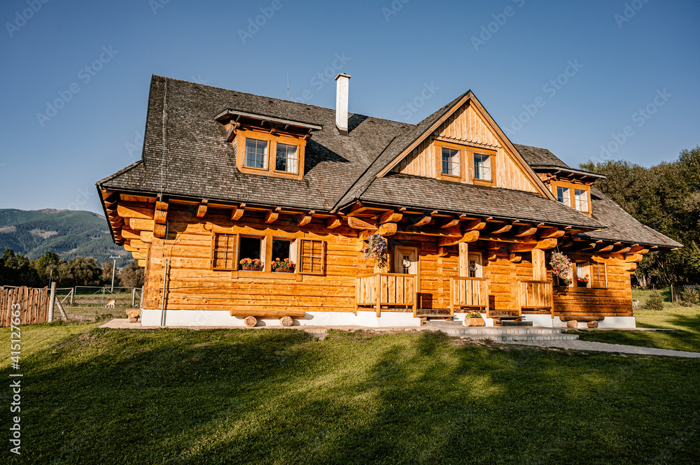 Wooden cottage in nature in sunny day. Recreation center in the mountains. Modern eko hausing in nature. - obrazy, fototapety, plakaty 