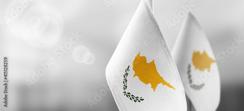 Fotografi Small national flags of the Cyprus on a light blurry background
