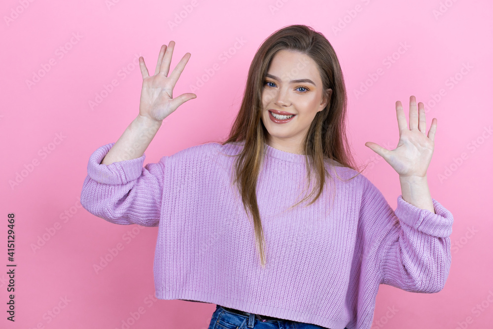 Young pretty woman with long hair standing over isolated pink background showing and pointing up with fingers number ten while smiling confident and happy Young pretty woman with long hair standing over isolated pink background showing and pointing up with fingers number ten while smiling confident and happy