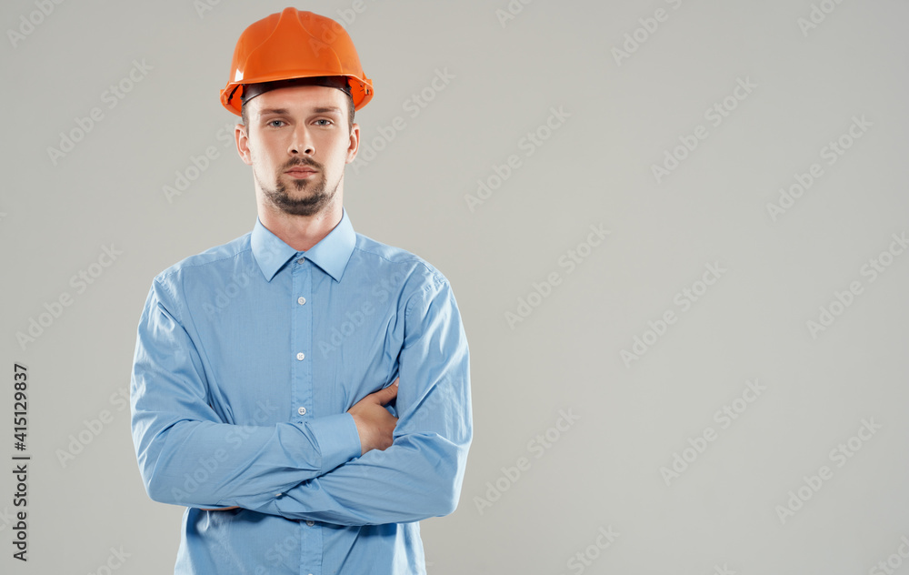 male architect in an orange helmet crossed his arms on his chest Copy Space male architect in an orange helmet crossed his arms on his chest Copy Space