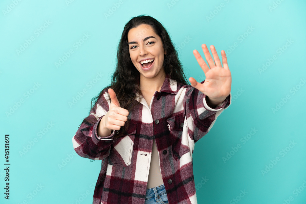 Young caucasian woman isolated on blue background counting six with fingers Young caucasian woman isolated on blue background counting six with fingers