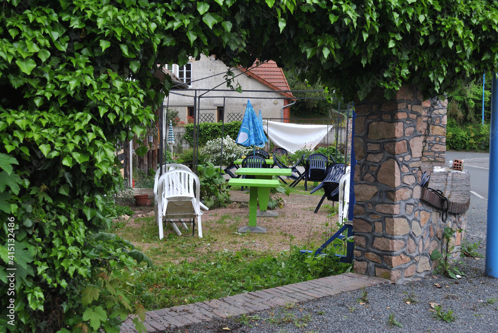 Chairs and Tables in Garden of Abandoned Outdoor Cafe