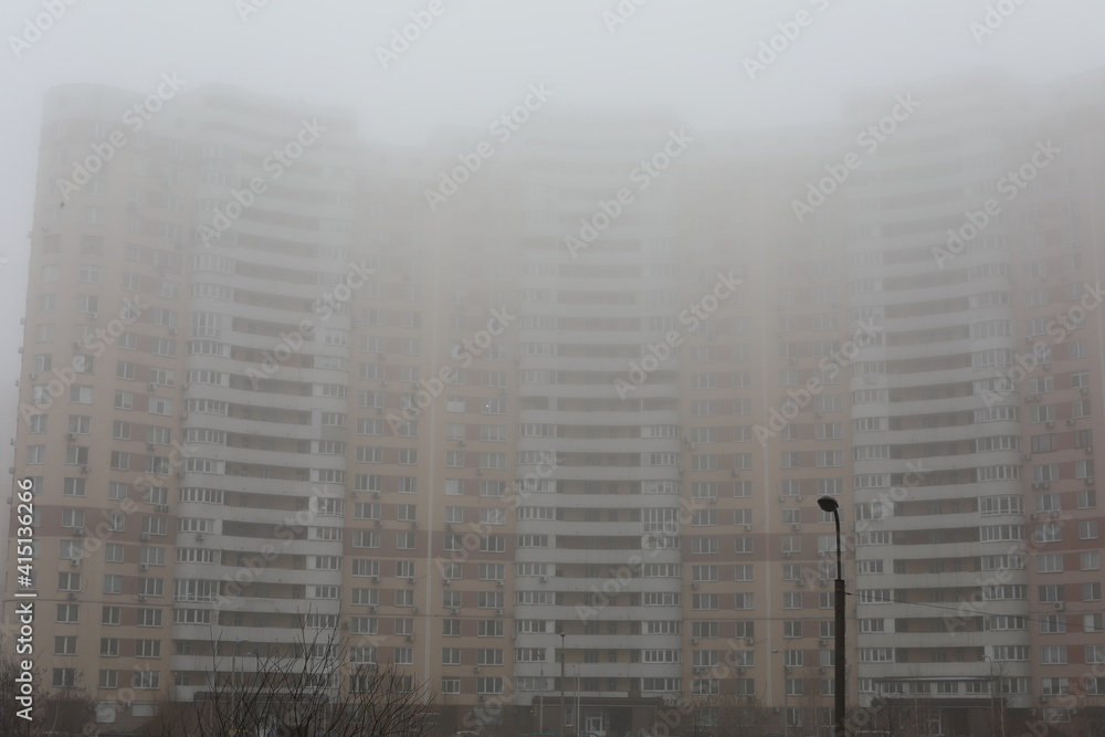 Obraz premium city skyline at night. View of residential skyscraper on a cloudy day. Modern cityscape of Ukrainian capital. Design of contemporary build in big city. Real urban style of residential building.
