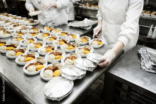 Fotografie Chefs are wrapping inflight food, toned