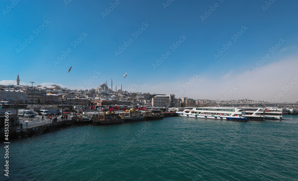 ISTANBUL, TURKEY - 17.Şubat .2021: the Golden Horn sea, passenger ferries, the famous Ottoman mosque Suleymaniye mosque dating from the 16th century tower and beyazıt.