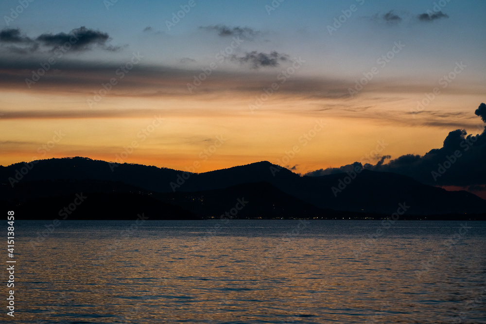 Sea view with sunset over the mountains.