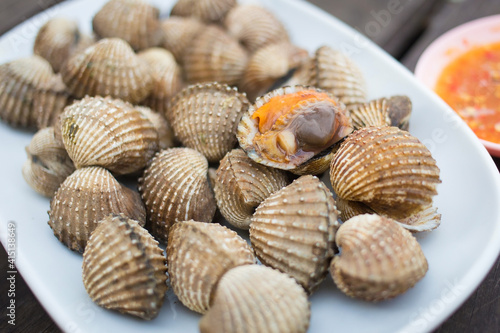 Boiled scallop is served with spicy sauce as a sea food in Thai style.