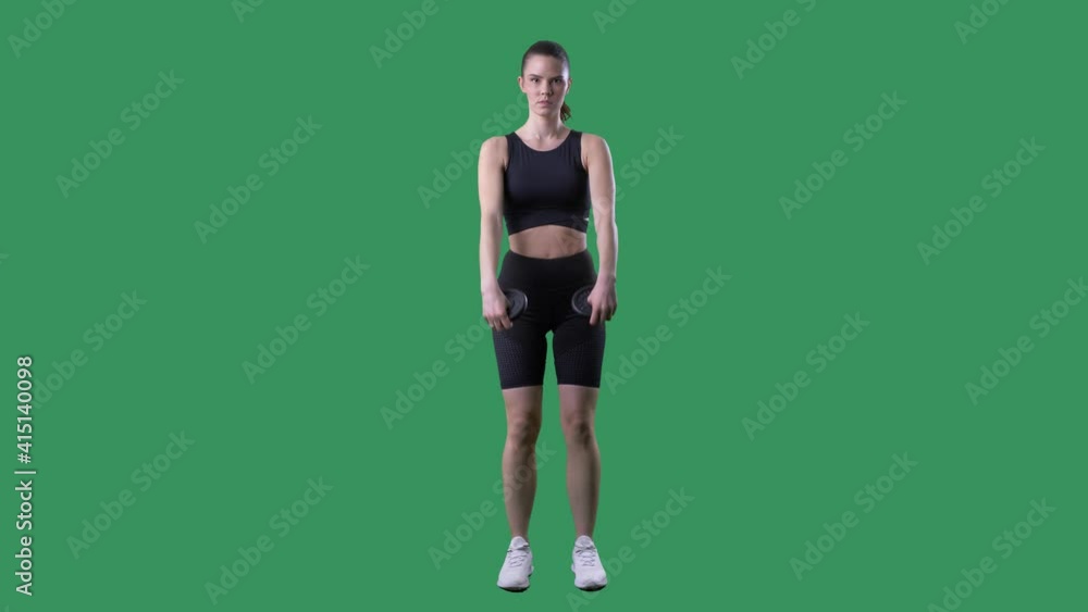 Gym woman doing shoulders front raise exercise with weight plates. Front Full body on chroma key green screen. Gym woman doing shoulders front raise exercise with weight plates. Front Full body on chroma key green screen.