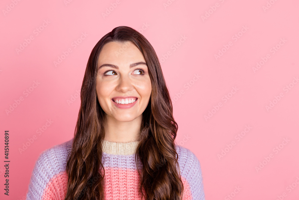 Photo of sweet shiny young woman wear knitted sweater smiling looking empty space isolated pink color background Photo of sweet shiny young woman wear knitted sweater smiling looking empty space isolated pink color background