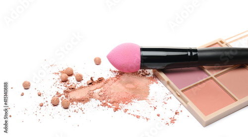 Makeup palette and powder pile with cosmetic applicator brush isolated on white background