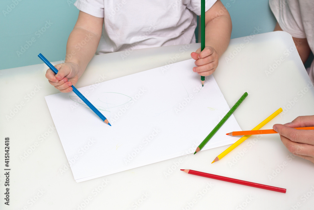 Lesson in art class. Boy drawing using color pencils Lesson in art class. Boy drawing using color pencils