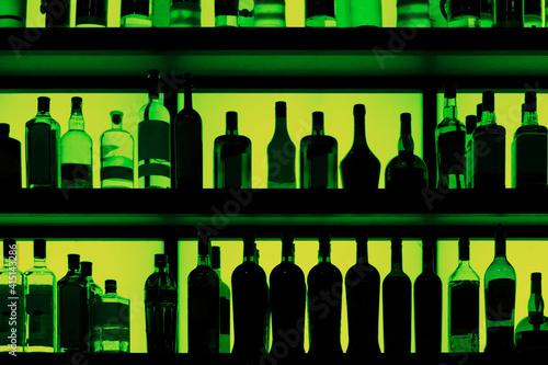 Rows of bottles sitting on shelf in a bar