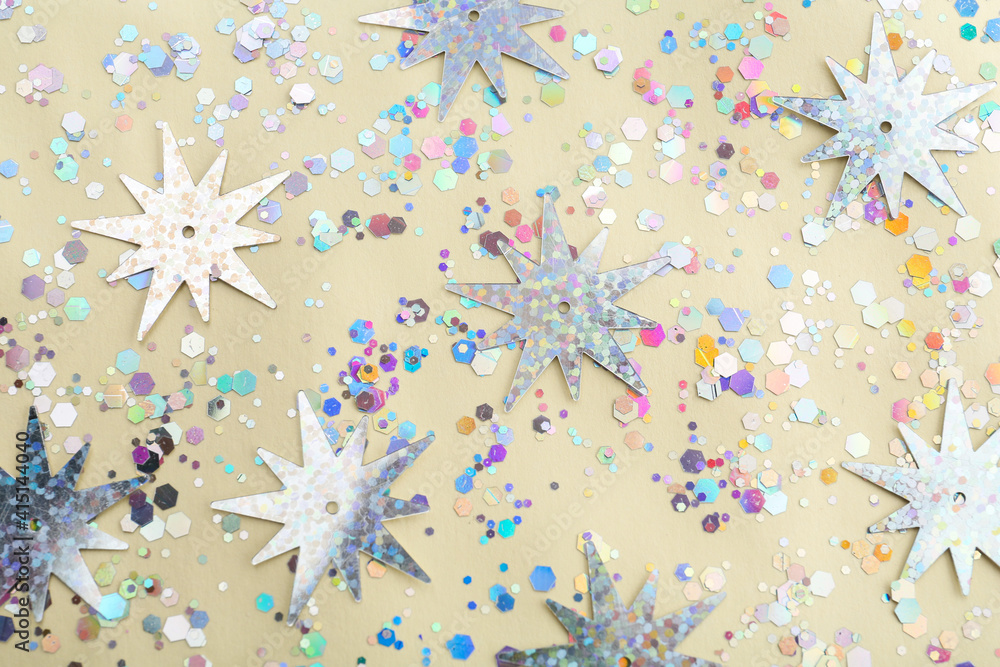 Shiny glitter on beige background, flat lay Shiny glitter on beige background, flat lay