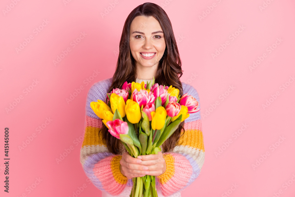 Portrait of pretty cheerful girl holding in hands bunch tulips mom mother day event isolated over pink pastel color background Portrait of pretty cheerful girl holding in hands bunch tulips mom mother day event isolated over pink pastel color background