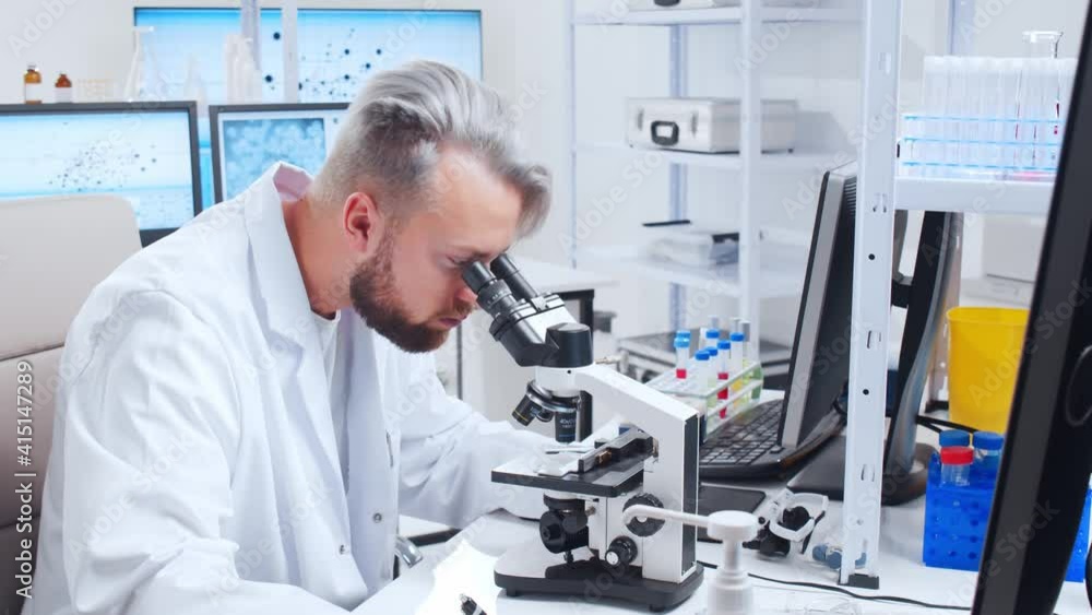 Professional team of scientists is working on a vaccine in a modern scientific research laboratory. Genetic engineer workplace. Future technology and science. Professional team of scientists is working on a vaccine in a modern scientific research laboratory. Genetic engineer workplace. Future technology and science.