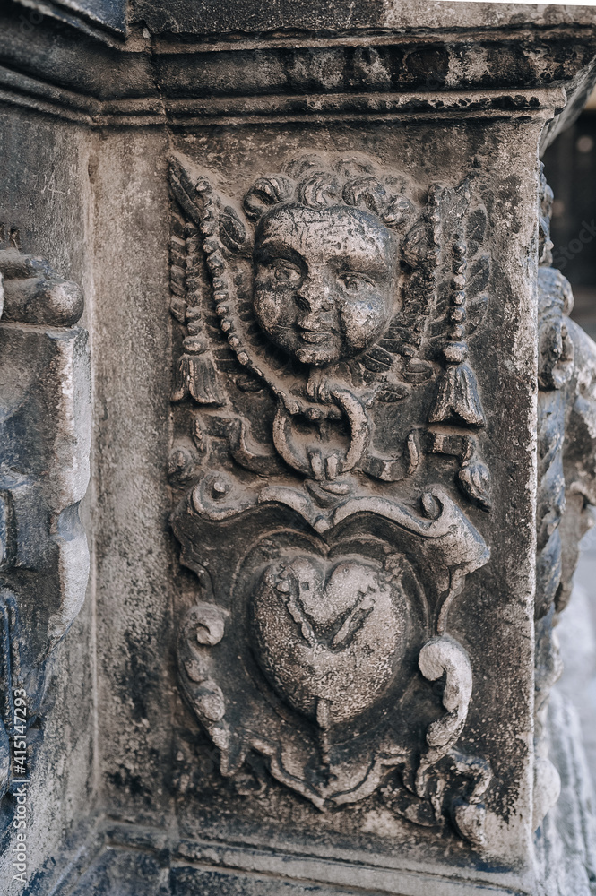 Fragment of the Boim chapel in Lviv, Ukraine. Old Renaissance architecture, relief and sculpture of seraphim, angel or cupid, , decorative details and elements close-up.
