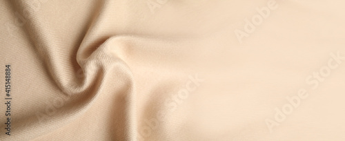 Beige soft cashmere fabric as background, closeup view with space for text. Banner design photo