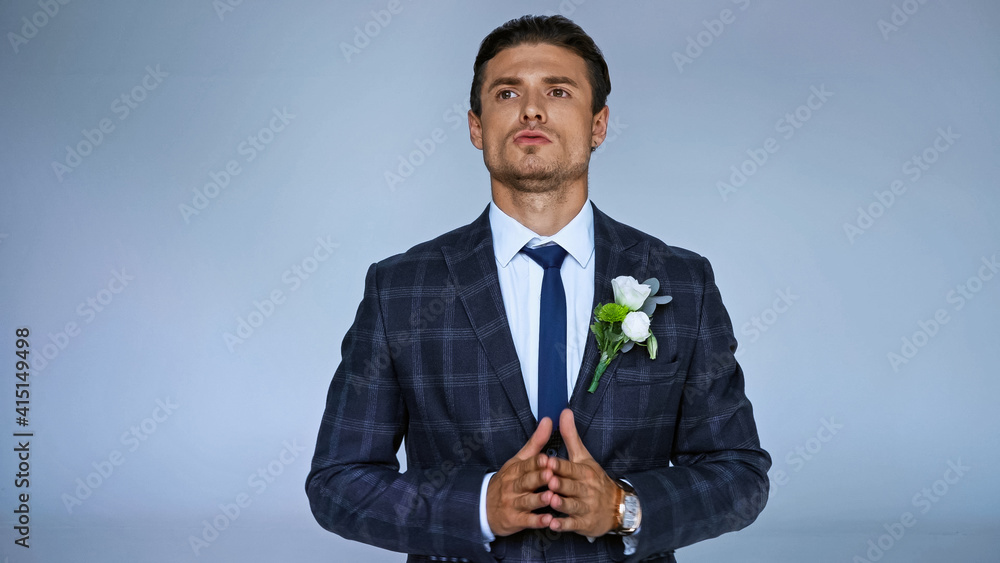 tense groom looking away while waiting isolated on blue tense groom looking away while waiting isolated on blue