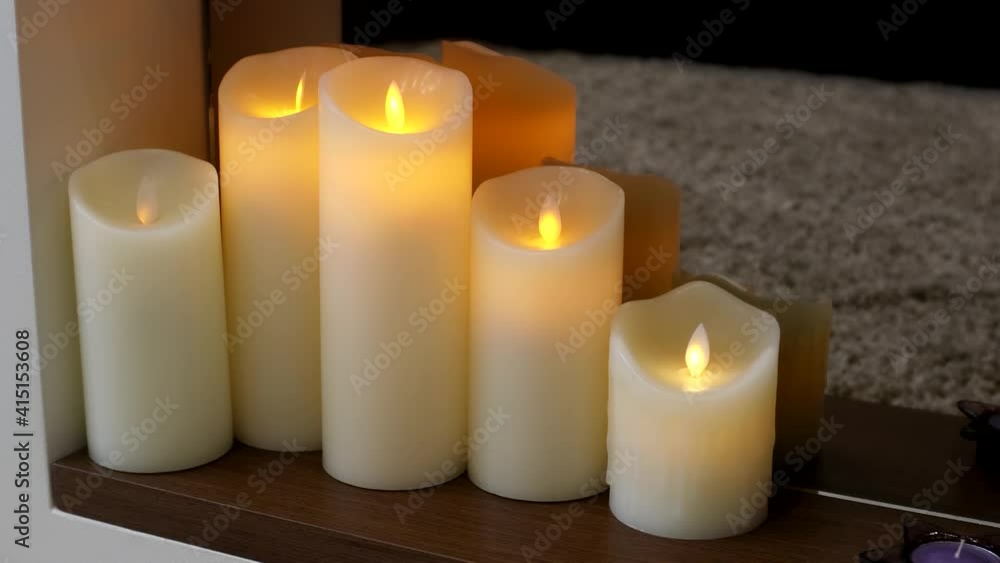 led electric and wax candles stand in the home fireplace led electric and wax candles stand in the home fireplace