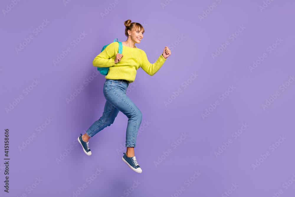 Full size profile photo of optimistic blond girl jump run wear green sweater jeans isolated on lilac color background
