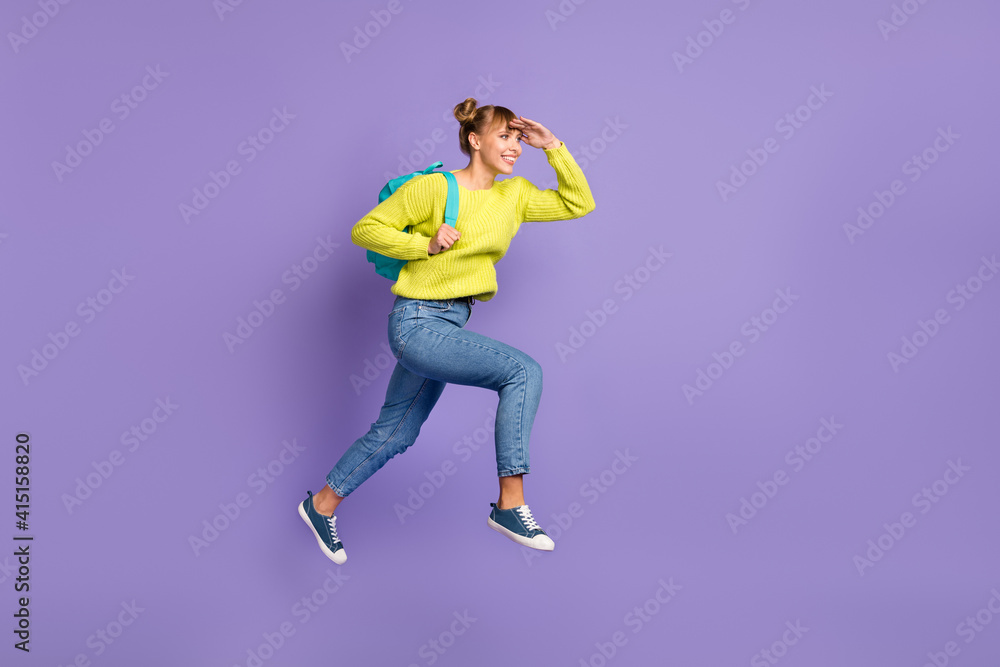 Full size profile photo of optimistic blond girl jump run look wear green sweater jeans isolated on lilac background