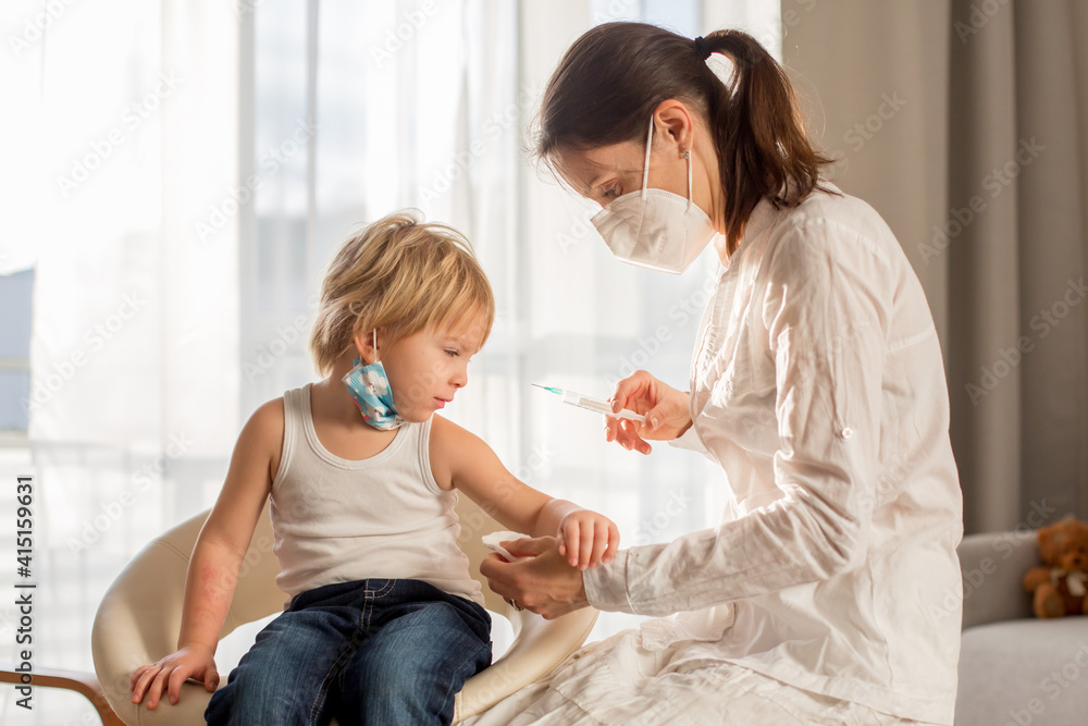 Little toddler boy, getting injection in consulting room from pediatrition Little toddler boy, getting injection in consulting room from pediatrition
