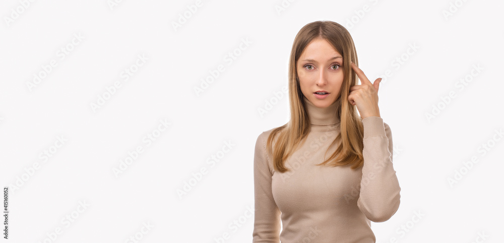 Photo of thinking young woman pointing with finger at head. Be smart and think. Studio shot, white backgroun Photo of thinking young woman pointing with finger at head. Be smart and think. Studio shot, white backgroun