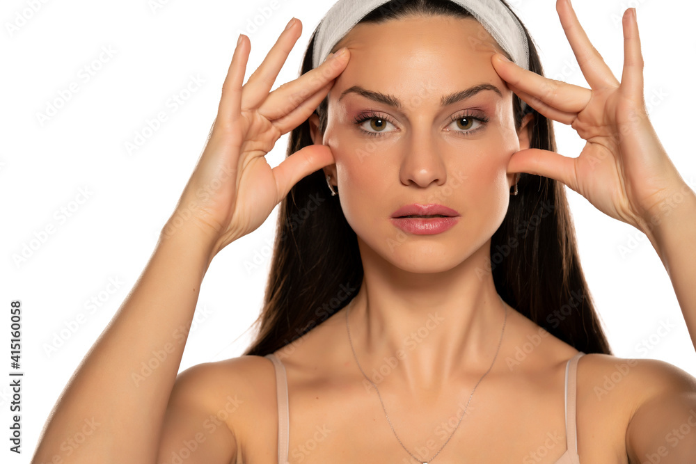 Fototapeta premium young woman tightening her face with her fingers