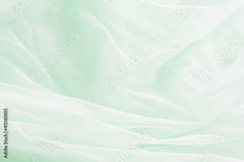 soft mint green tulle fabric background © Iveta