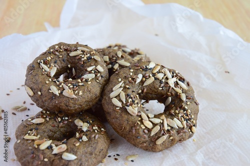 Vegan gluten free bagels topped with sunflower seeds, flax seeds and sesame seeds. Healthy breakfast food. 