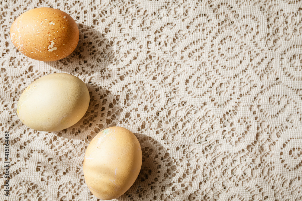Beige Easter eggs on a beige lace tablecloth. Copy space Beige Easter eggs on a beige lace tablecloth. Copy space