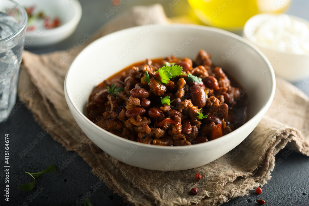 Homemade beef chili con carne with sour cream