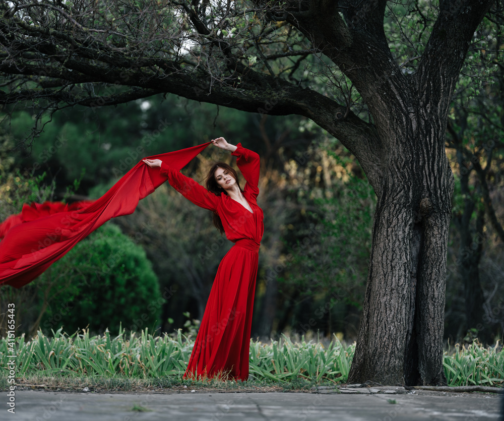 elegant woman in red dress posing near tree luxury summer elegant woman in red dress posing near tree luxury summer