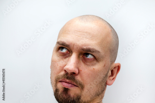 a man's face with a beard and bald, different expressions of emotion,
