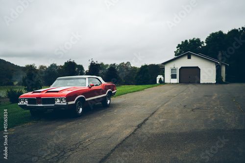 Vintage car parked near old barn
