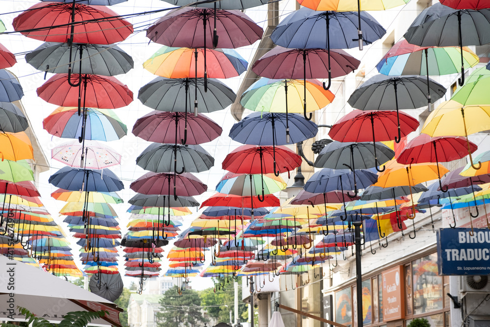 A group of different colored umbrella In ROmania in center of Iasi Town in a summer day with sun A group of different colored umbrella In ROmania in center of Iasi Town in a summer day with sun