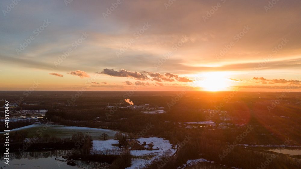 Aerial view of a beautiful and dramatic sunset over a forest lake reflected in the water, landscape drone shot. Blakheide, Beerse, Belgium. High quality photo Aerial view of a beautiful and dramatic sunset over a forest lake reflected in the water, landscape drone shot. Blakheide, Beerse, Belgium. High quality photo