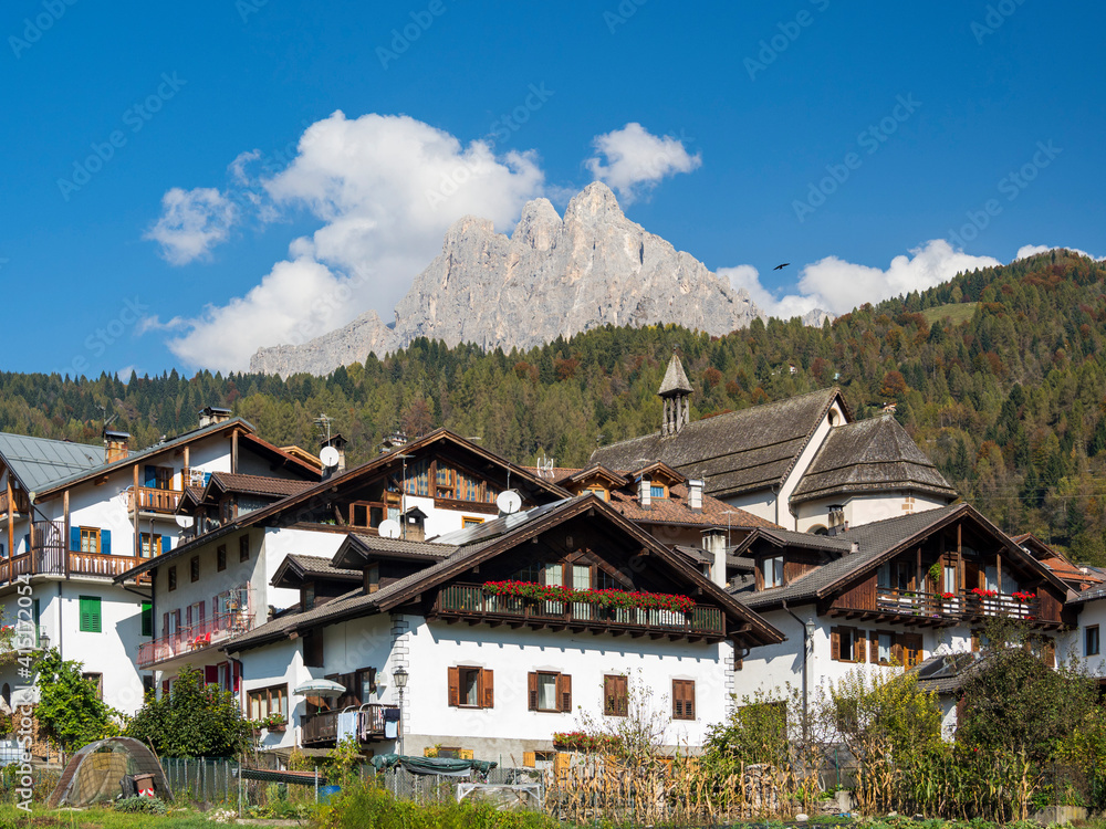 Traditional architecture of the Primiero. Tonadico in the valley of Primiero in the Dolomites of Trentino. The Pale di San Martino in the background. Italy.
