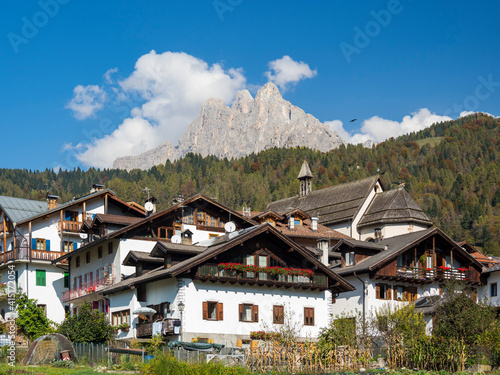 Traditional architecture of the Primiero. Tonadico in the valley of Primiero in the Dolomites of Trentino. The Pale di San Martino in the background. Italy.