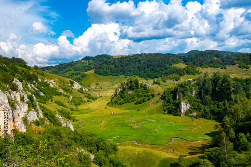 view from the hill with the green valley and the hollow rocks without trees