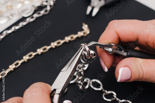 The process of making handmade jewelry.Female hands close-up. Нandicraft concept.