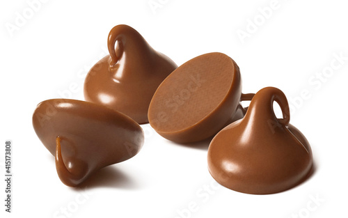 Milk chocolate drops or chips isolated on white background