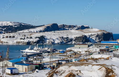 view of the closed sea bay with the village in winter, Krabozavodskoe, Shikotan, 2020