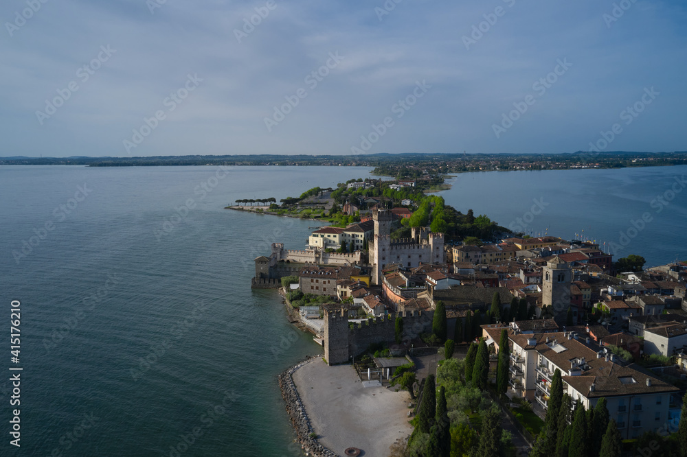 The historical part of the city of Sirmione on the background of Colombare Lake Garda Italy