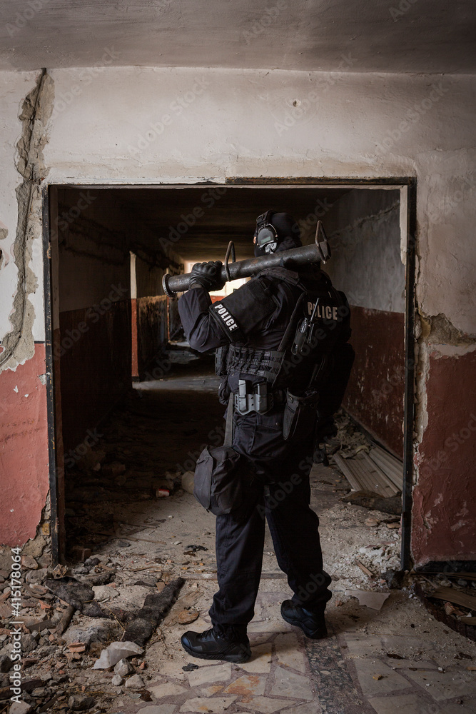 a special police officer holds a pistol, a sword and a grenade in his hands. a policeman in uniform poses in a ruined building. a special policeman in full combat gear ready for a mission and a task. a special police officer holds a pistol, a sword and a grenade in his hands. a policeman in uniform poses in a ruined building. a special policeman in full combat gear ready for a mission and a task.