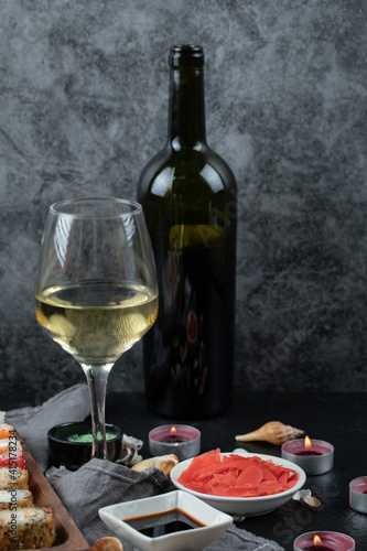 Fototapeta Naklejka Na Ścianę i Meble -  Sushi set with a bottle and glass of white wine