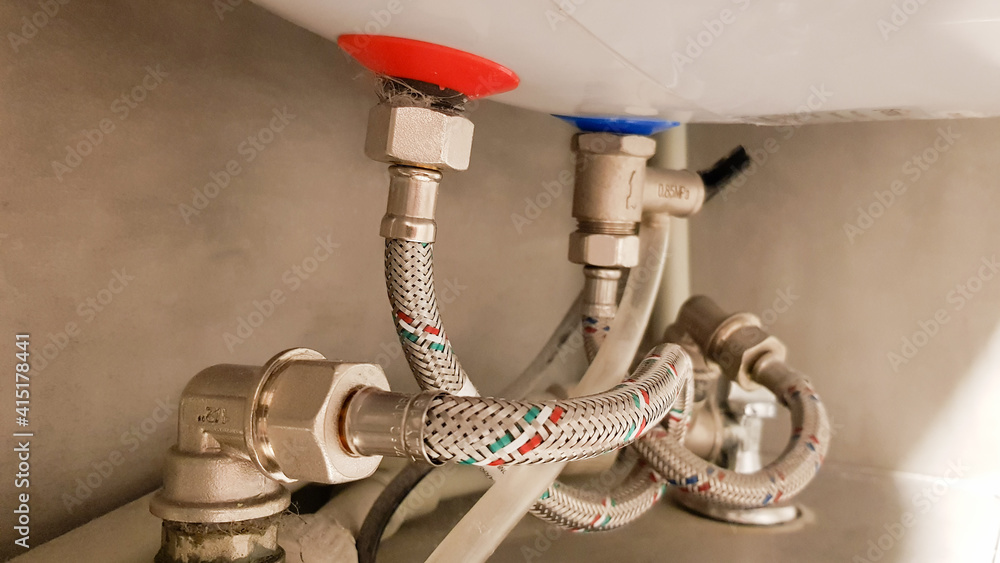 Connection of water supply, hot and cold water to the boiler. Hose for hot  and cold water in the bathroom. Plumbing connections for a domestic  electric water heater. Stock Photo | Adobe
