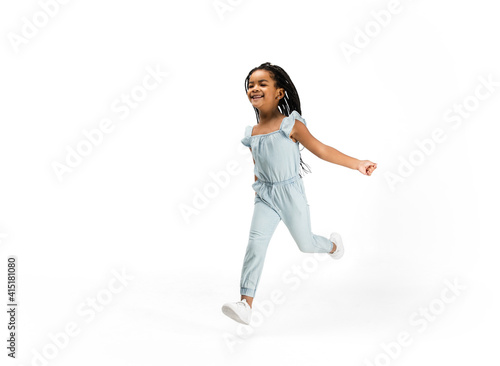Happy longhair brunette little girl isolated on white studio background with copyspace for ad. Looks happy, cheerful, sincere. Childhood, education, human emotions, facial expression concept.